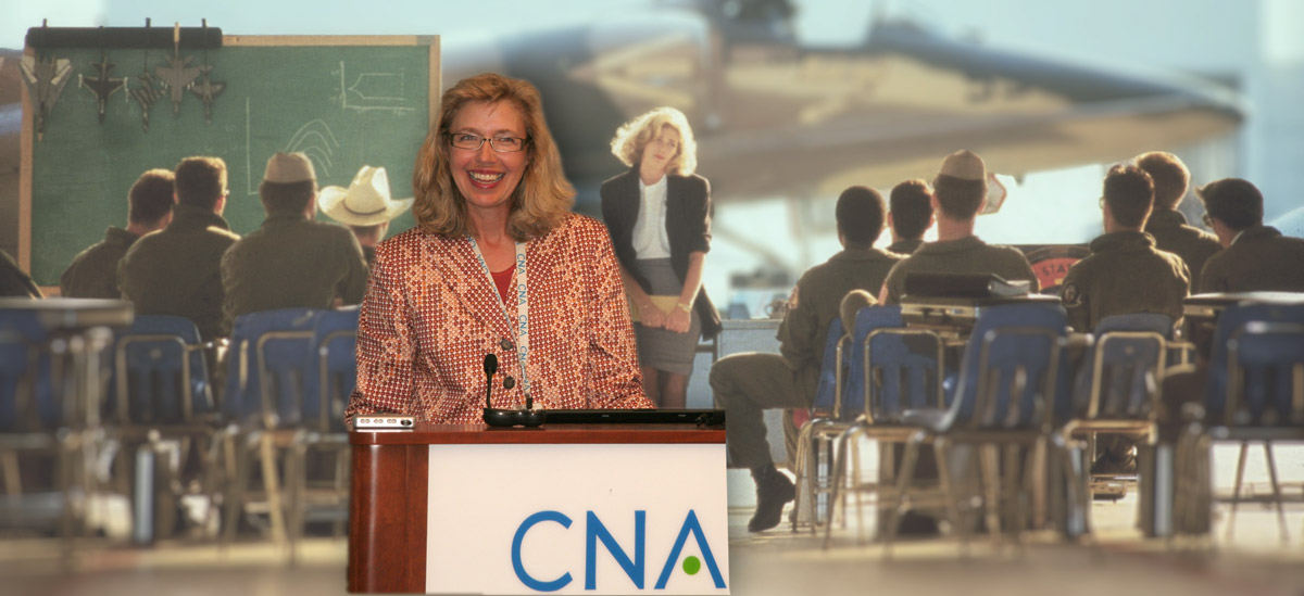 Christine Fox speaking with a film still of Charlie Blackwood in the background