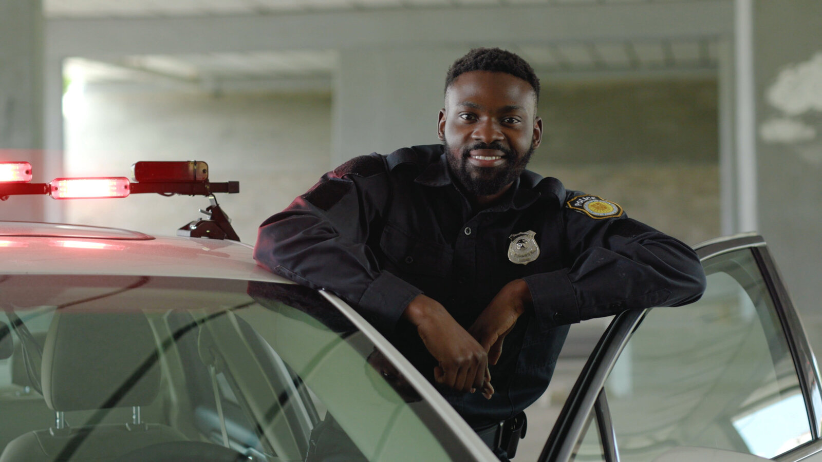 Officer standing in open police car door