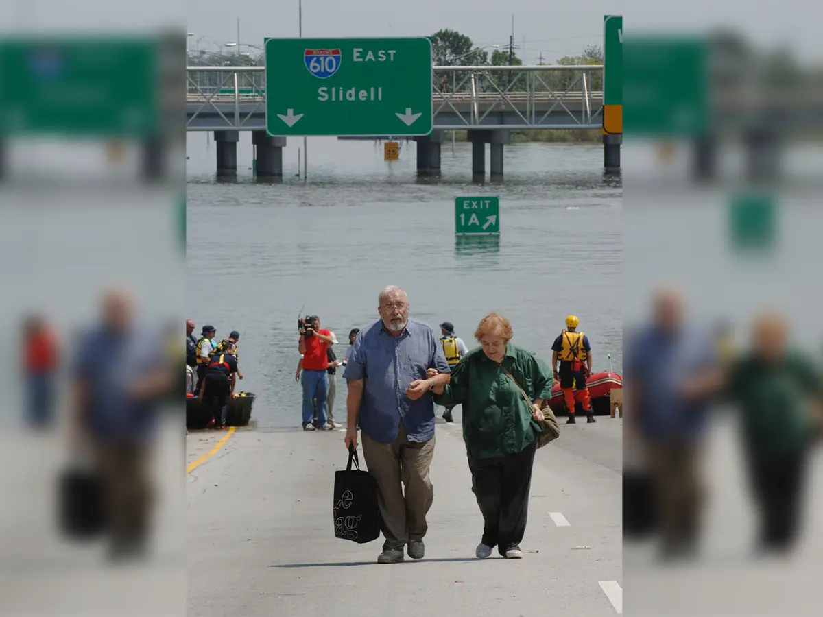 Older couple walking away from flooded road