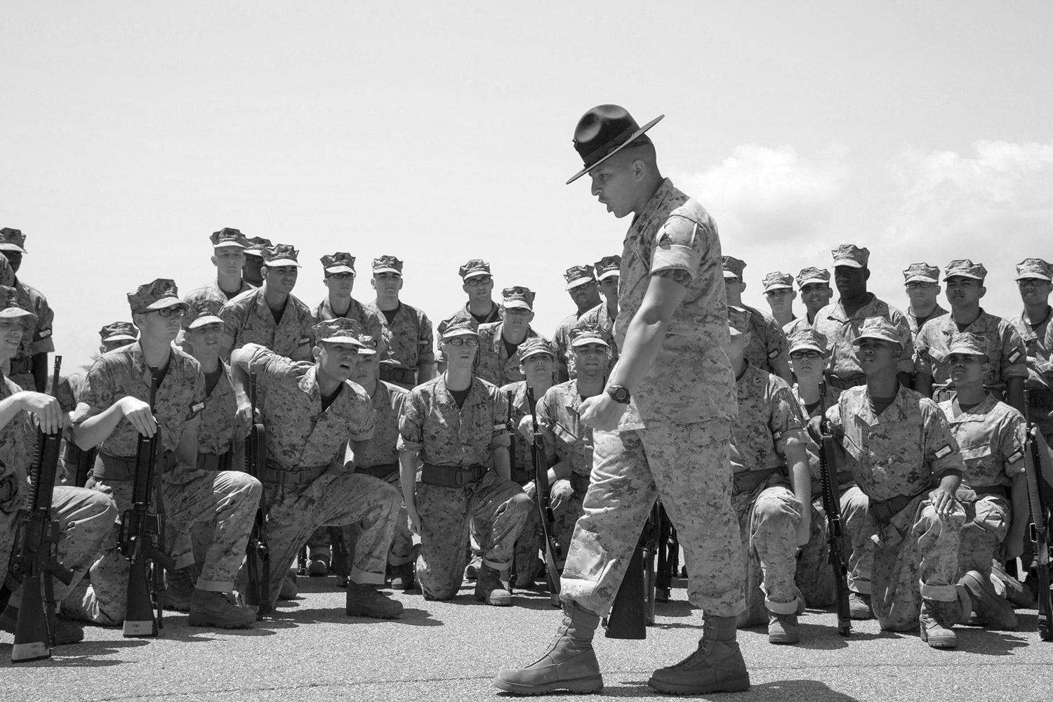 drill sergeant talking to seated recruits