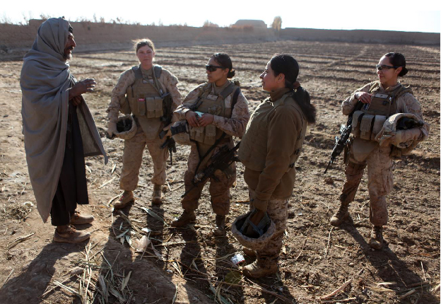 U.S. Marines assigned to a female engagement team (FET) speak with a local Afghan man in his compound during a patrol in Marjah, Helmand Province, Afghanistan