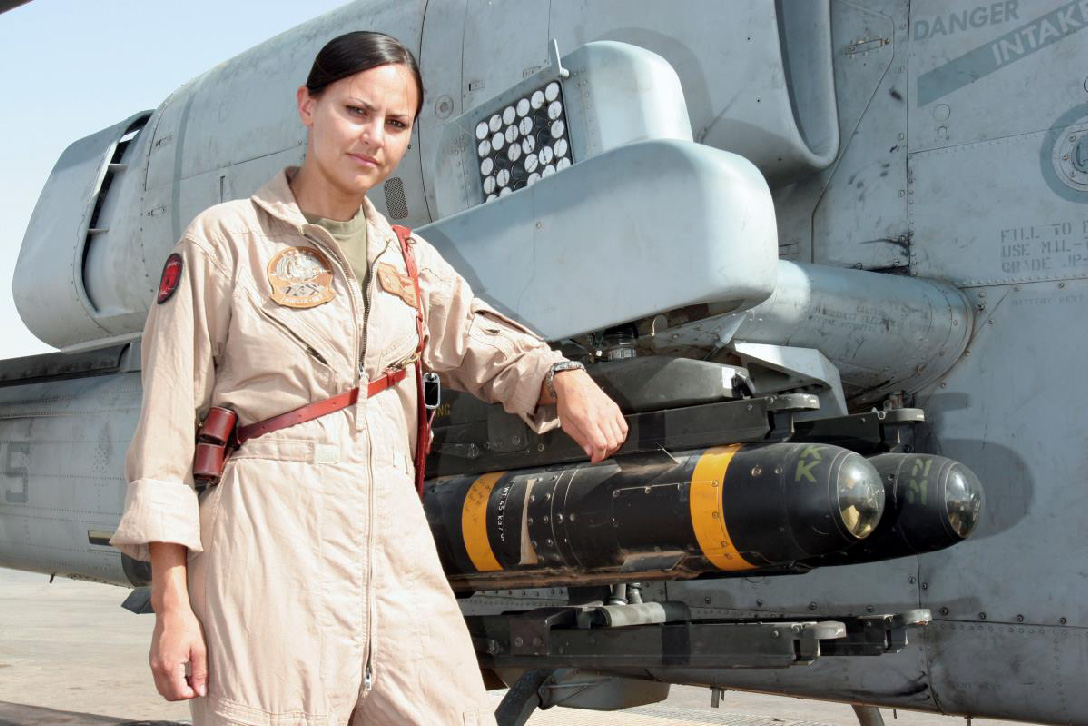 Captain Jessica M. Moore, an AH-1 Cobra pilot with Marine Light Attack Helicopter Squadron 167, is pictured with her aircraft in Al Asad, Iraq, 2005. Photo By: Cpl James D. Hame, USMC.