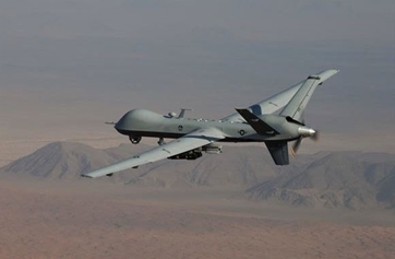 An MQ-9 Reaper, armed with GBU-12 Paveway II laser guided munitions and AGM-114 Hellfire missiles, piloted by Col. Lex Turner flies a combat mission over southern Afghanistan.