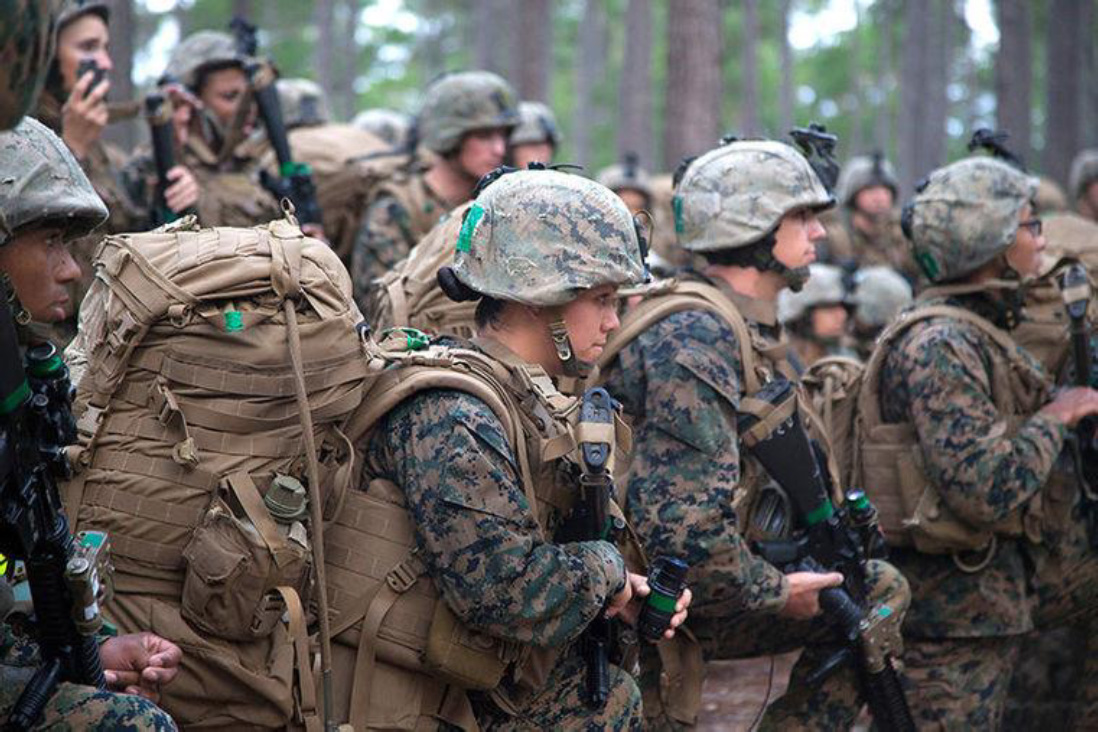 U.S. Marine Corps PFC Cristina Fuentes Montenegro of Delta Company, Infantry Training Battalion (ITB), School of Infantry-East (SOI-E), kneels during an accountability drill after completing a 20-kilometer hike at Camp Geiger, North Carolina, Oct. 28, 2013. Delta Company is the first company at ITB with female students as part of a measured, deliberate, and responsible collection of data on the performance of female Marines when executing existing infantry tasks and training events. (U.S. Marine Corps photo by Cpl Anthony Quintanilla, Combat Camera, SOI-E/ Released)