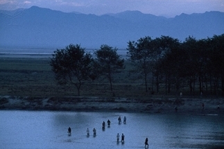 Brahmaputra River, India: people crossing the Brahmaputra River at six in the morning.