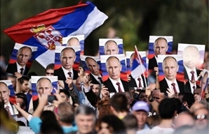 Serbian flag with Putin photos in a crowd