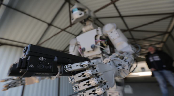 Anthropomorphic robot holding firearm in left hand