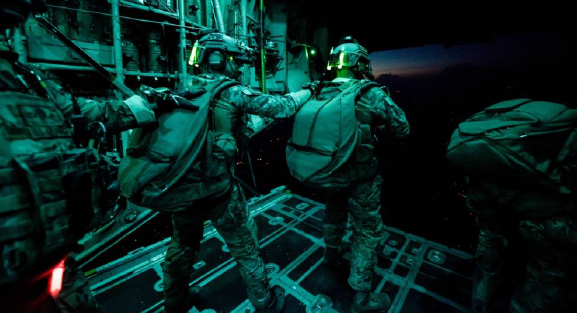National Guardsmen with Company A, 2nd Battalion, 20th Special Forces Group (Airborne) prepare to exit a C-130 Hercules during a night training mission over Muscatatuck, Ind.