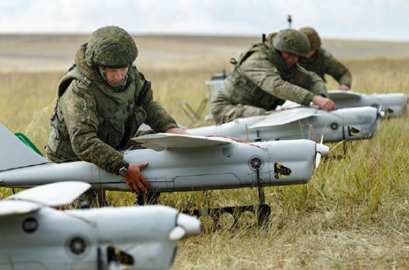 Soldiers inspecting unmanned drones