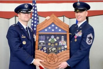 Col Darren Halford, 9th Operations Group commander (left), presents CMSgt James Crites, 9th Operations Group superintendent, his shadow box during Crites’ retirement ceremony at Beale Air Force Base, CA, Jan. 9, 2015. Crites served more than 30 years in the Air Force.