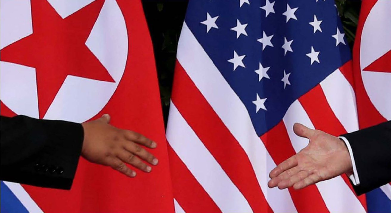 handshake in front of U.S. and North Korean flag