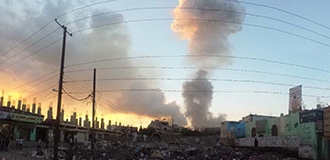 A smoke plume rising from an armed conflict