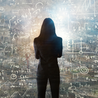 Silhouette of a person standing in front of a chalkboard