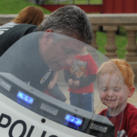 Motorcycle police officer with a child