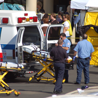 EMS workers removing a gurney from an ambulance