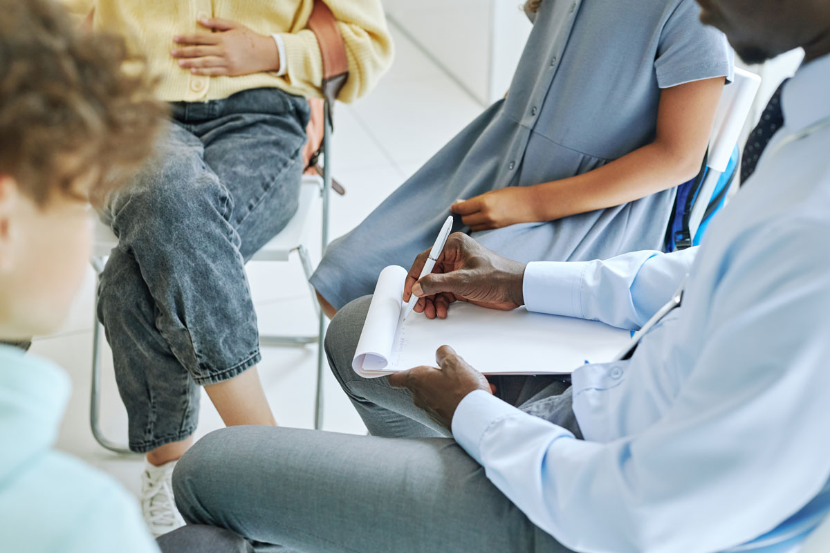 cropped image of a circle of people in a group discussion session